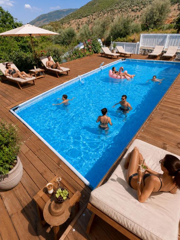a group of people swimming in a swimming pool at Villa Semana Ksamil in Ksamil