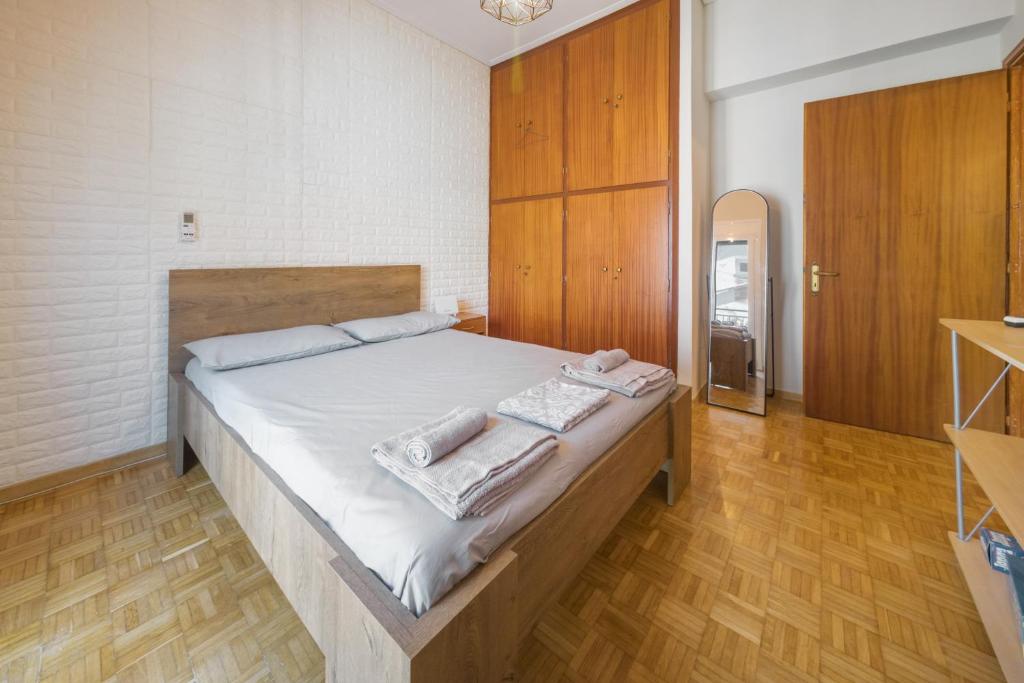 a bedroom with a bed with towels on it at ChaKo Stay Solutions Studio in Lamía