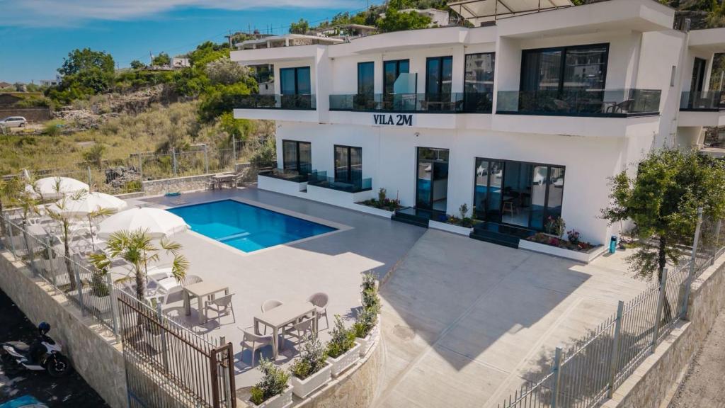 an aerial view of a house with a swimming pool at Vila 2M in Sarandë