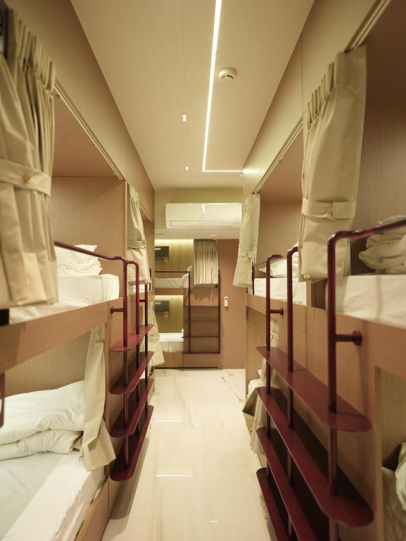 a row of bunk beds in a room at Dormstel - Unit of AHM Hotels & Resorts Pvt Ltd in Vadodara
