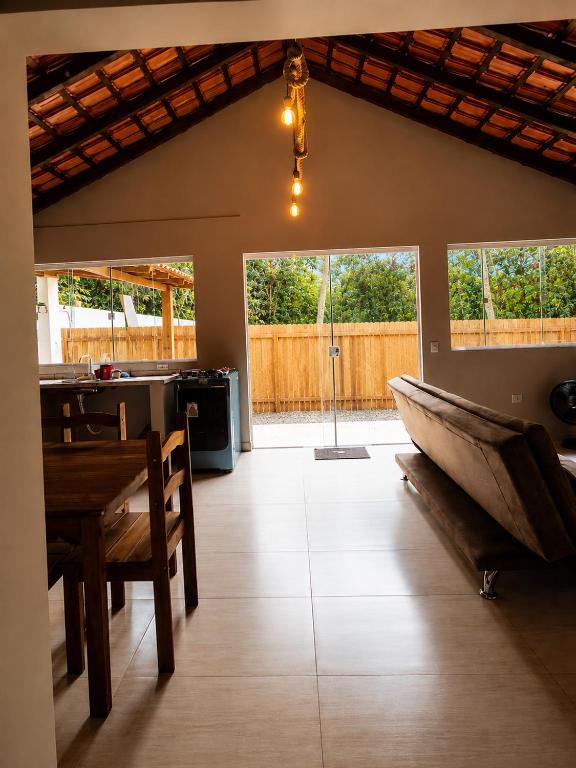 a living room with a table and a boat on the floor at Canto Sereno Refúgio entre Praias e Ilhas in Paraty
