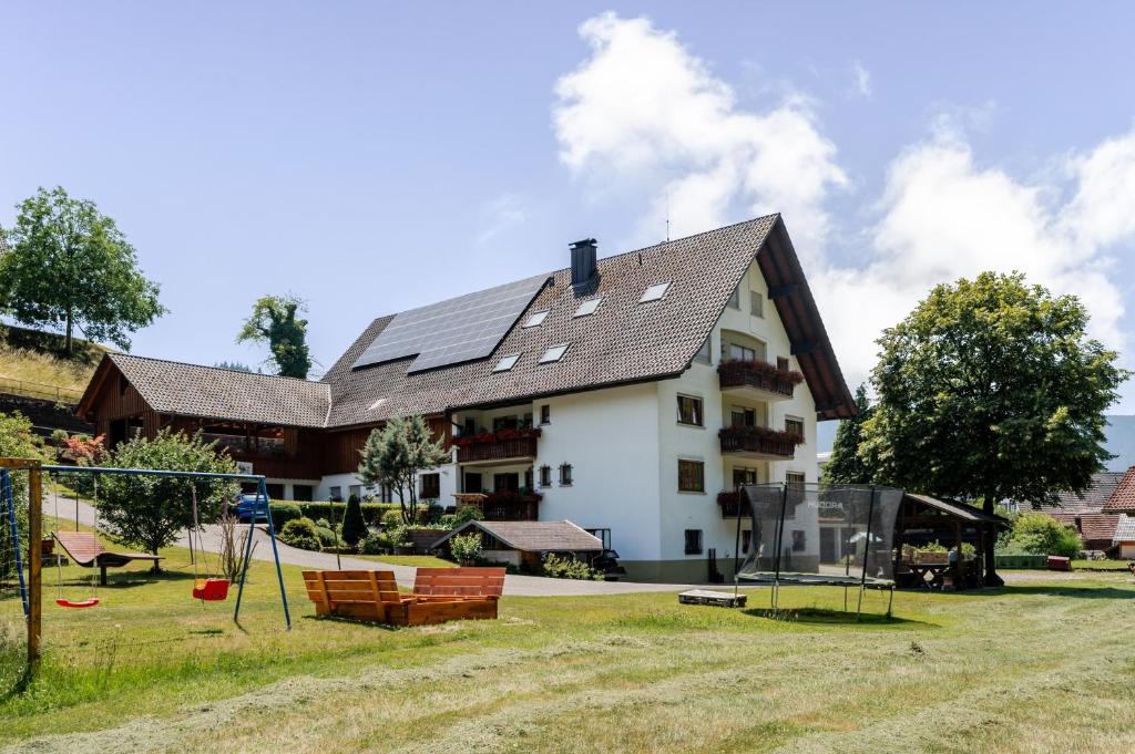 a house with a playground in front of it at Ferienwohnung Bergfranzenhof in Oppenau