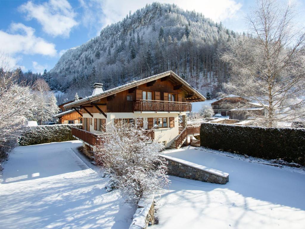 a house in the snow with a mountain at Chalet Bolay in Montriond