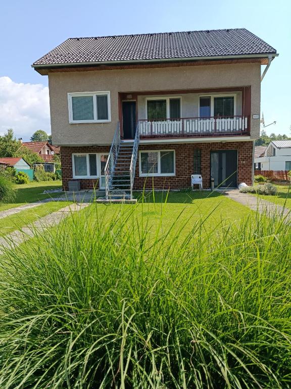 a large house with a lawn in front of it at Ubytovanie Kubik 473 in Liptovský Mikuláš