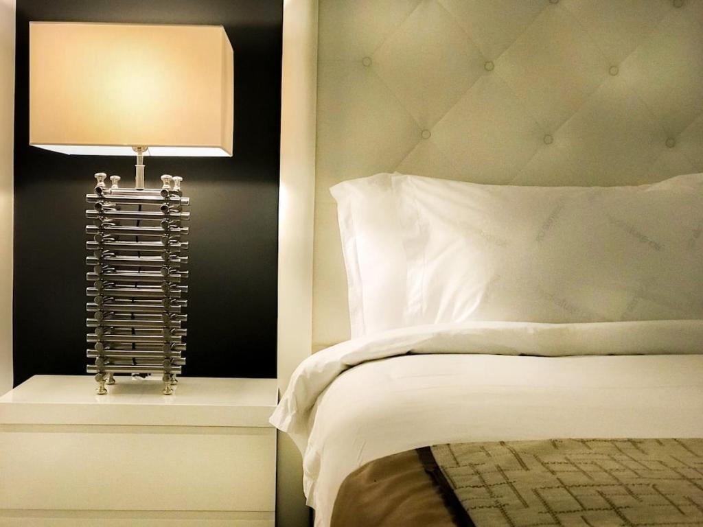 a bedroom with a bed with a lamp next to it at Only 350 yards from Eagle Beach! in Palm-Eagle Beach