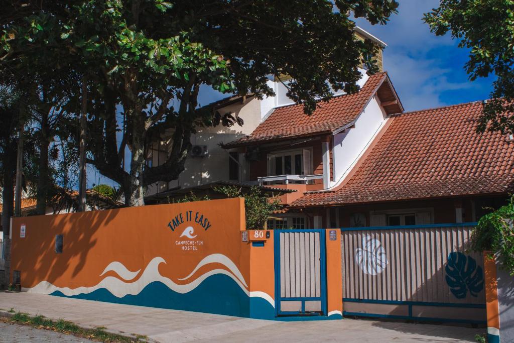 a fence in front of a house at Take it Easy Hostel in Florianópolis