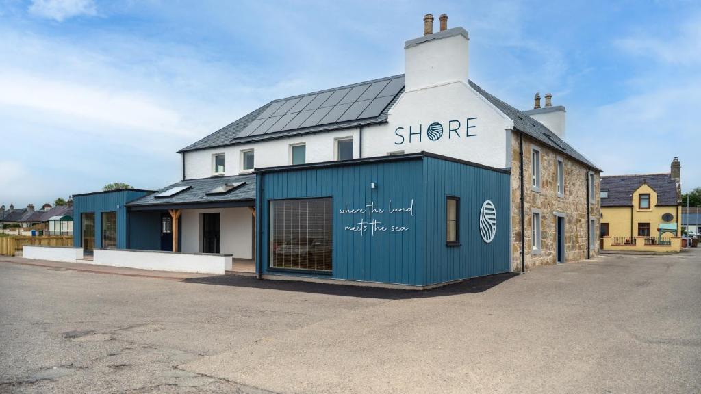 a blue building with the words shere on it at Shore Hotel in Balintore