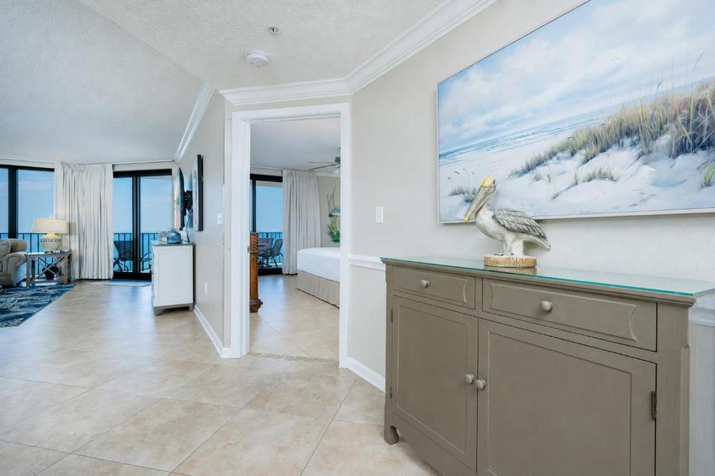 a living room with a large painting on the wall at Phoenix X 809 in Orange Beach
