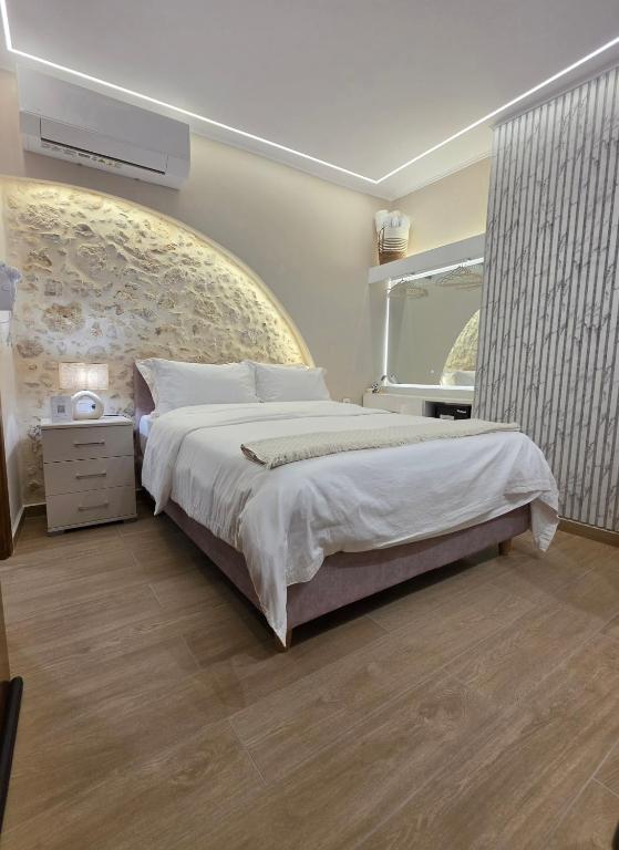 a bedroom with a large bed and a window at LUM Luxury Studios in Rethymno