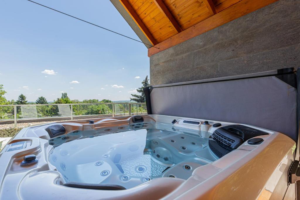 a jacuzzi tub sitting on top of a house at Elite House Platina Apartment in Leányfalu