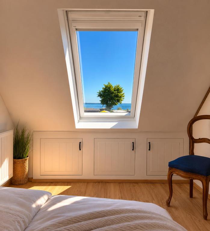 a bedroom with a window with a view of the ocean at Kajüte mit Meerblick & eigener Terrasse in Sierksdorf