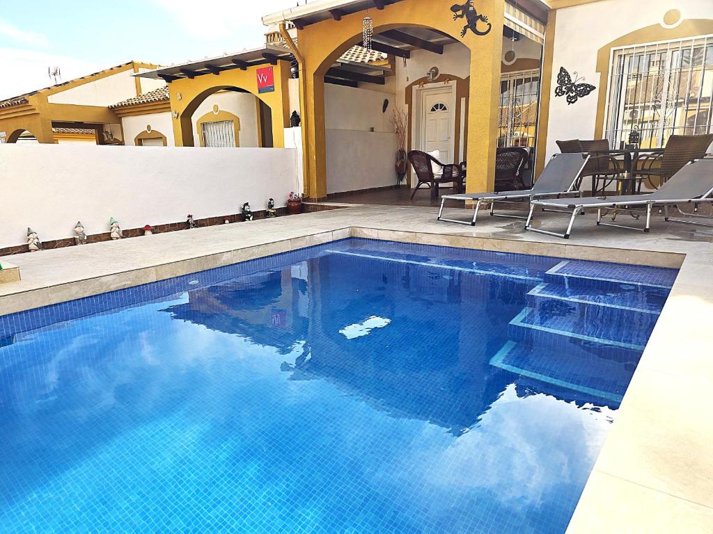 a swimming pool with blue water in a house at Bluemoon in Mazarrón