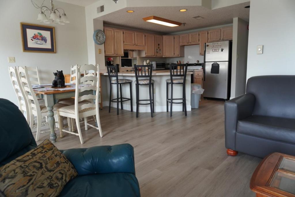 a living room and kitchen with a couch and a table at River Place Condos #410 3BD in Pigeon Forge