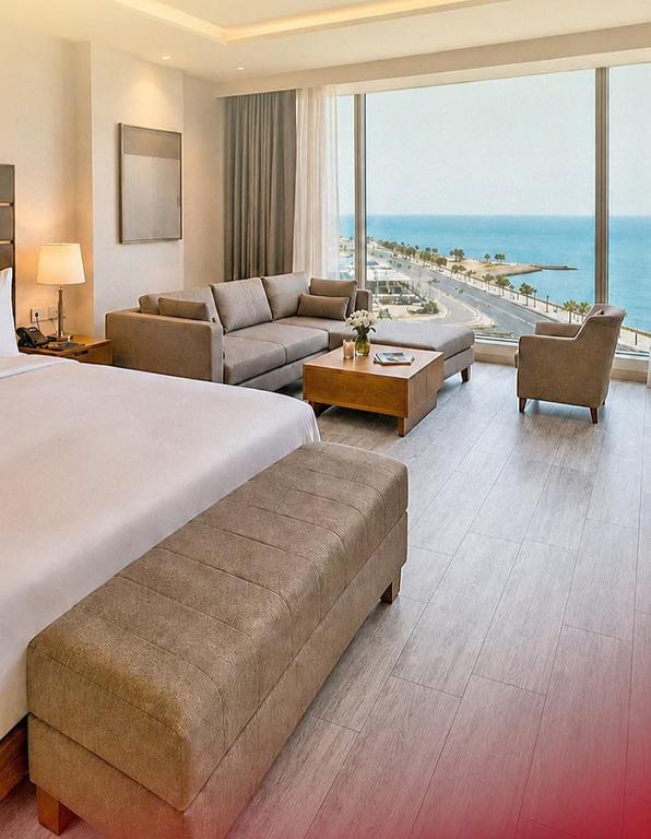 a large hotel room with a bed and a living room at فندق بلازا أثينيه Plaza Athenee Hotel in Kuwait
