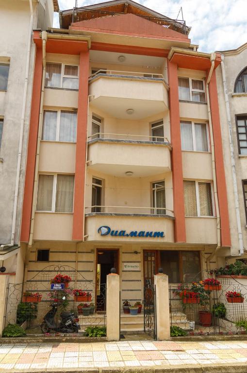 a building with a sign on the front of it at Къща за гости ДИАМАНТ in Primorsko