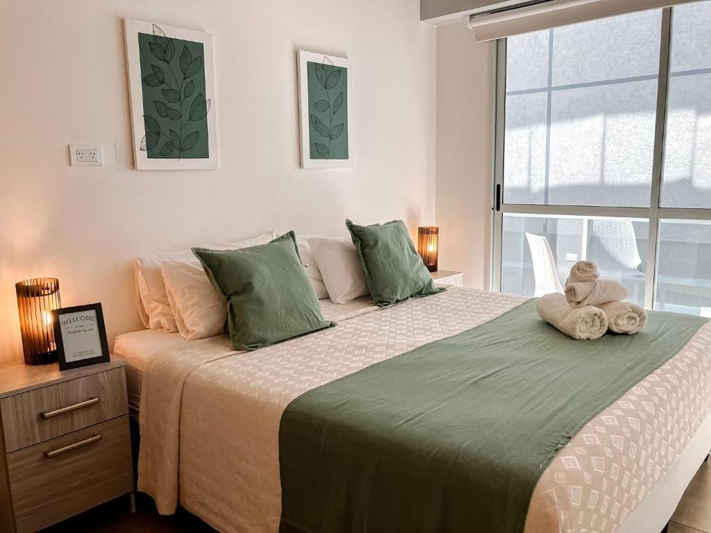 a bedroom with a bed with two stuffed animals on it at Cómodo departamento centro de Salta by BEDBOOK in Salta