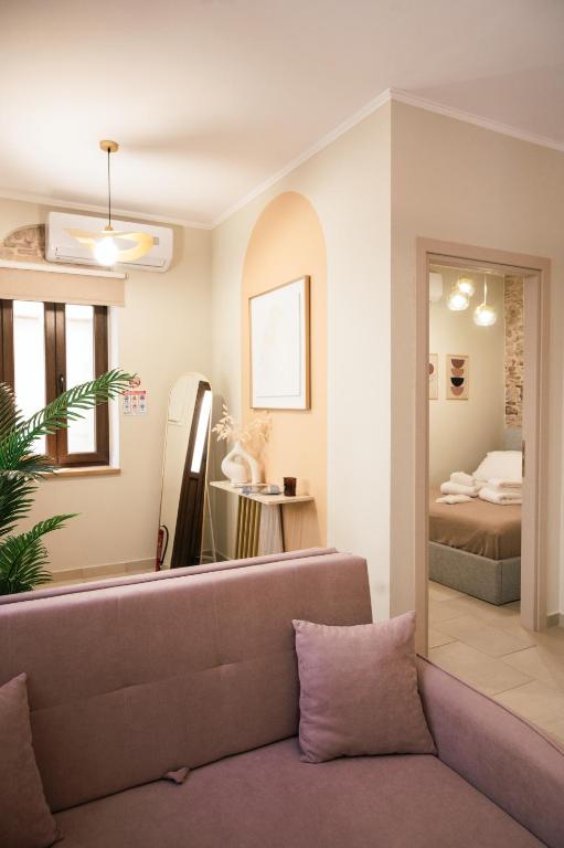 a living room with a couch and a bedroom at Kallia Castle apartments in Chios