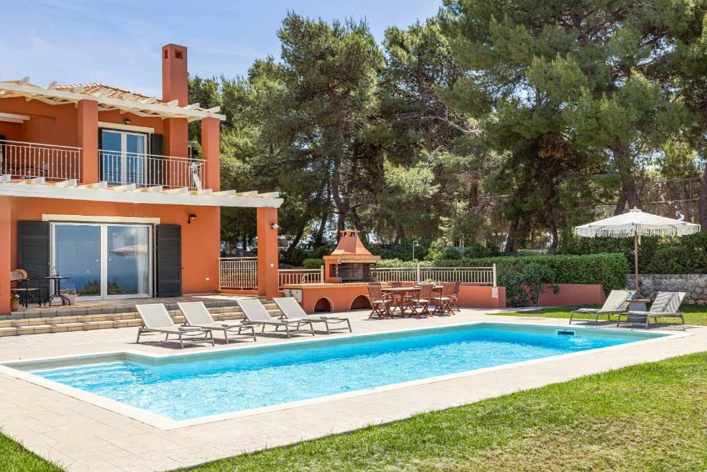 a villa with a swimming pool and a house at Villa Agnandi in Lakíthra