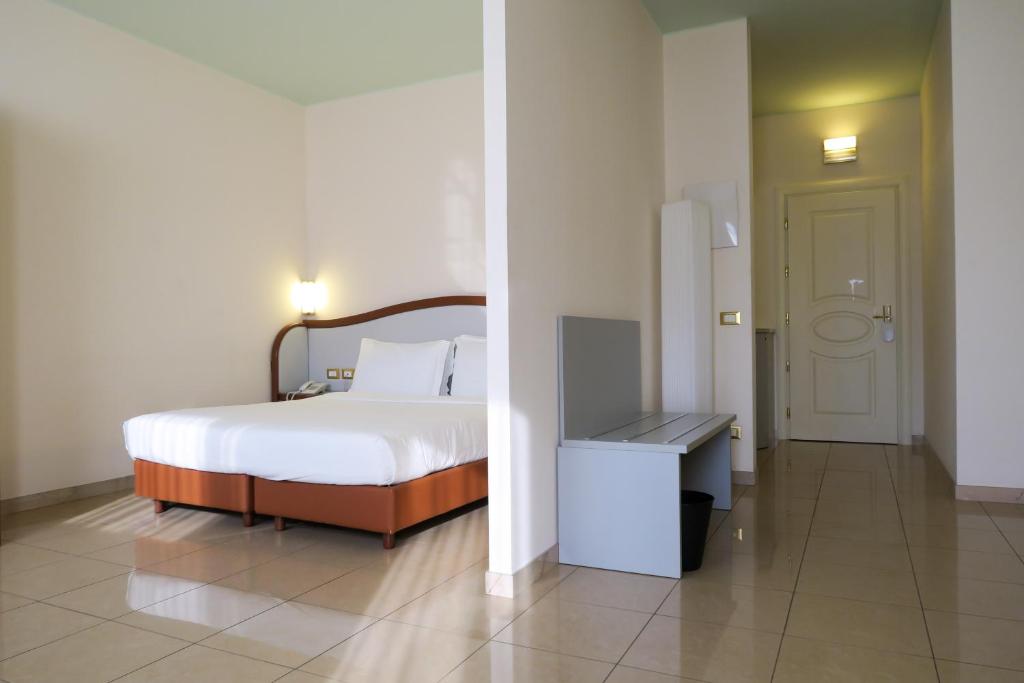 Postel nebo postele na pokoji v ubytování Hotel Verdi