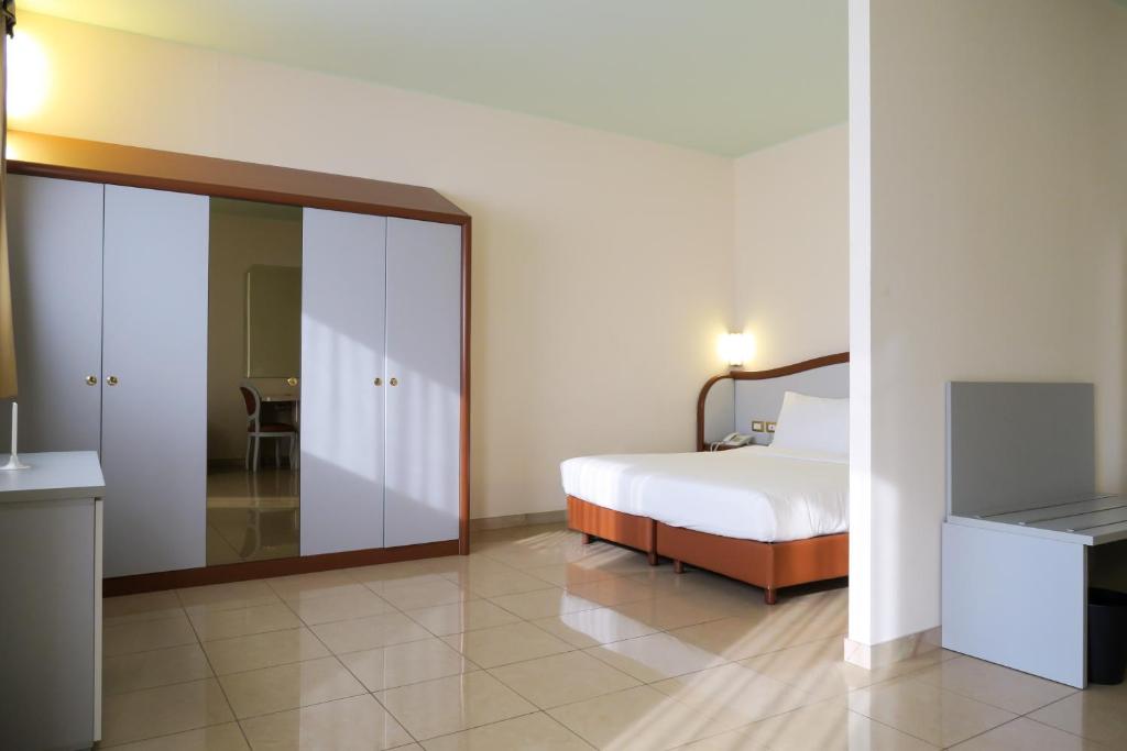 Postel nebo postele na pokoji v ubytování Hotel Verdi