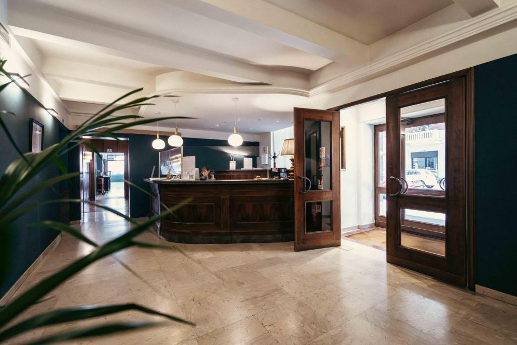 a large room with a kitchen and a lobby at Hotel Italia in Turin
