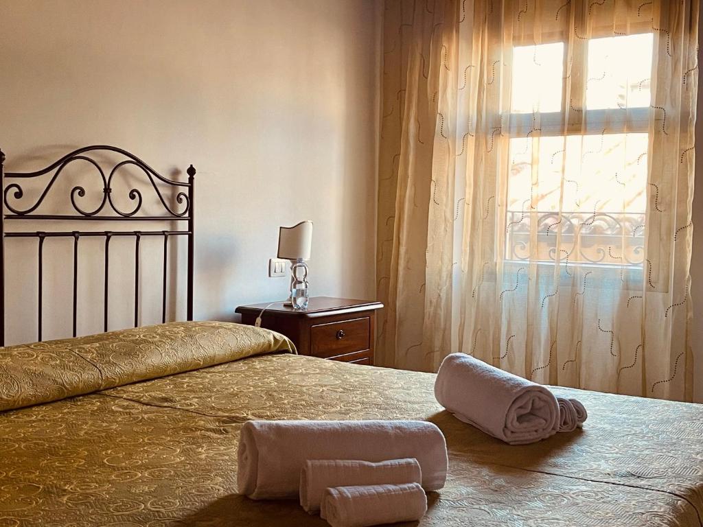 a bedroom with a bed with two towels on it at Affittacamere La Mattonata in Città di Castello