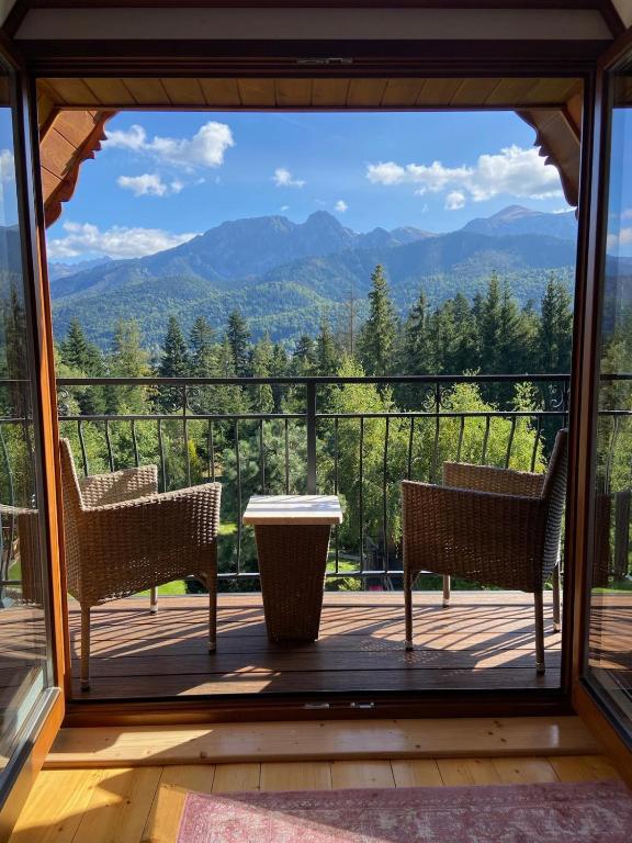 a screened in porch with a view of the mountains at Willa Sosna in Kościelisko