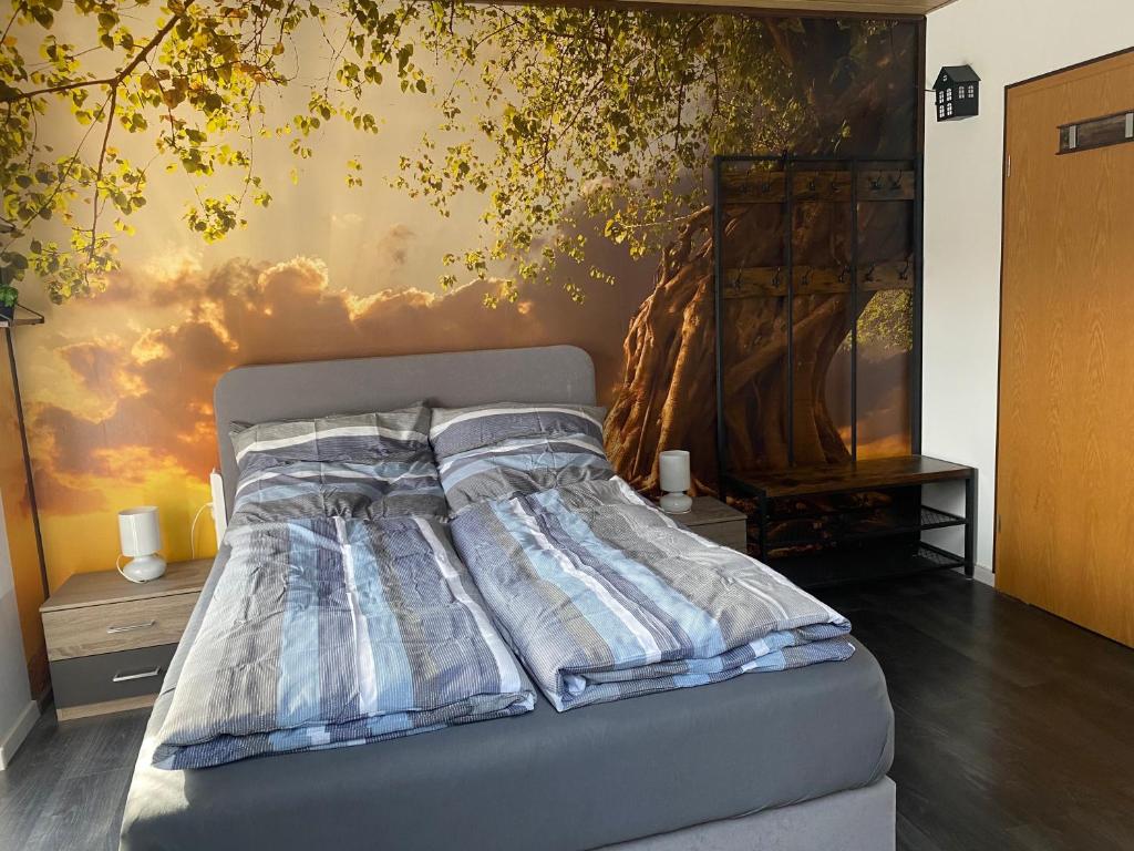a bed in a room with a painting on the wall at Bassd scho in Ebensfeld