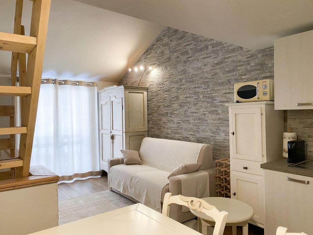 a living room with a couch and a table at Fiocco di Neve - AffittiPontediLegno in Passo del Tonale