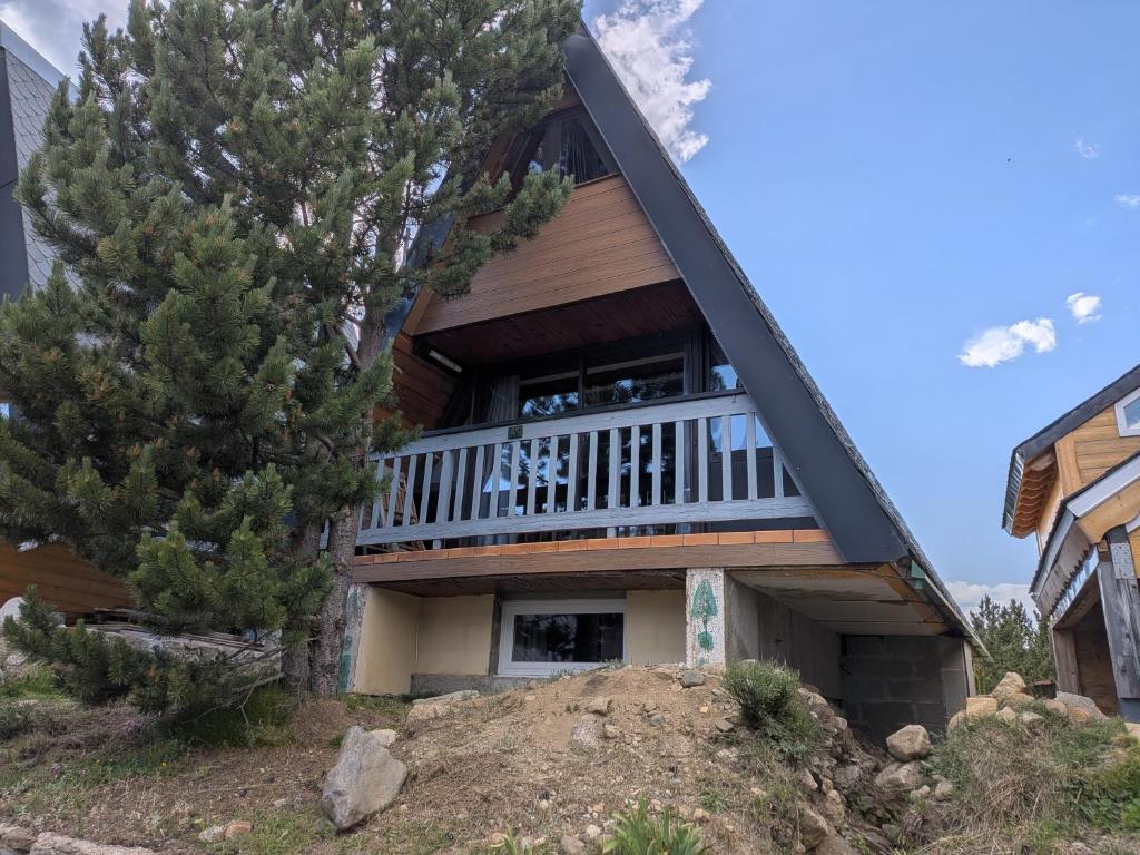 a house on a hill with a balcony at Chalet Les Angles in Les Angles