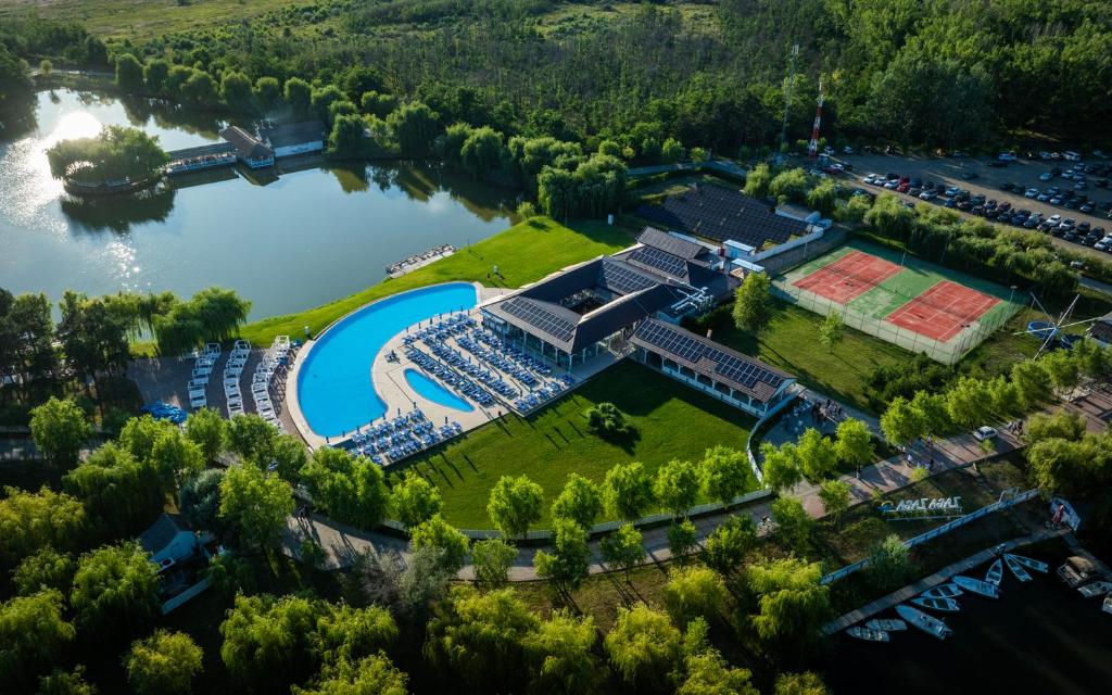 an aerial view of a resort with a pool and a river at Zaga Zaga Sat in Tecuci