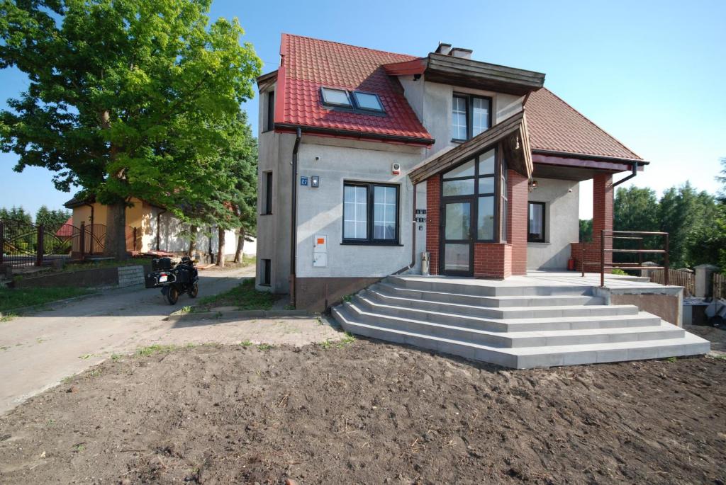 a house with stairs in front of it at Noclegi Dywity Barczewskiego 27 in Dywity