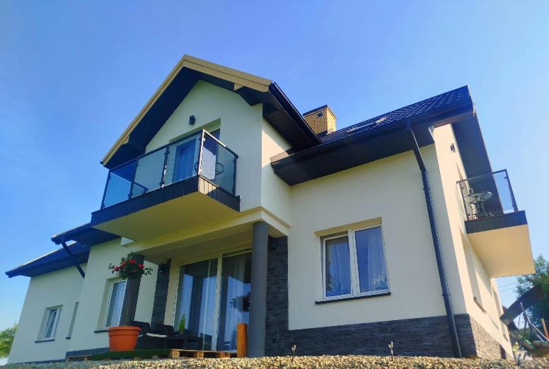 a large white house with windows and a balcony at Gorczańska EKO-SFERA in Wola Piskulina