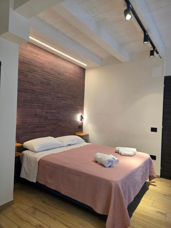 a bedroom with a large bed with two towels on it at AL 54 Accommodation - Premium in San Benedetto del Tronto