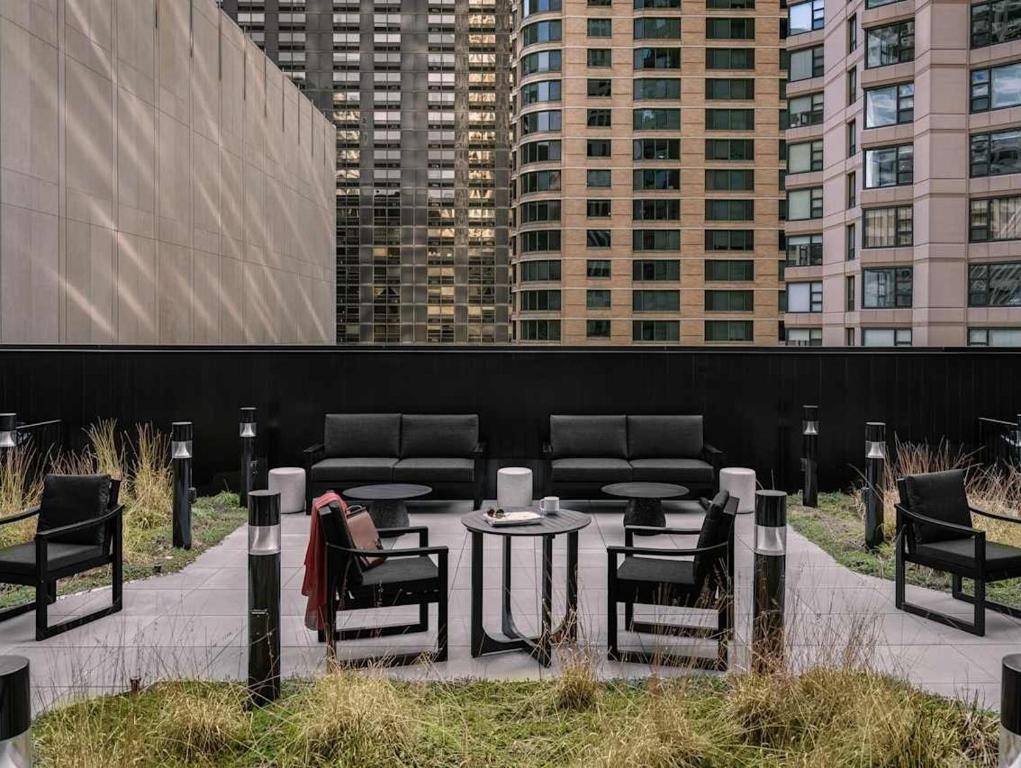 a patio with chairs and a table and a couch at Kasa Lake Shore Chicago in Chicago