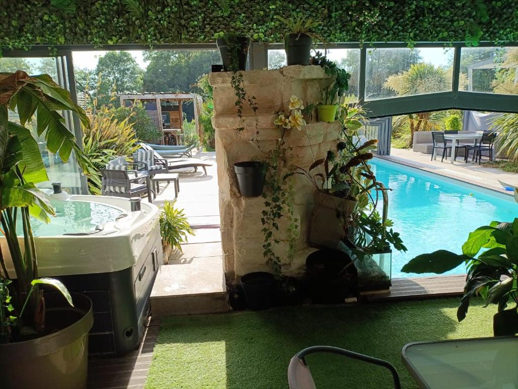 a patio with plants and a swimming pool at Desirad in La Clisse