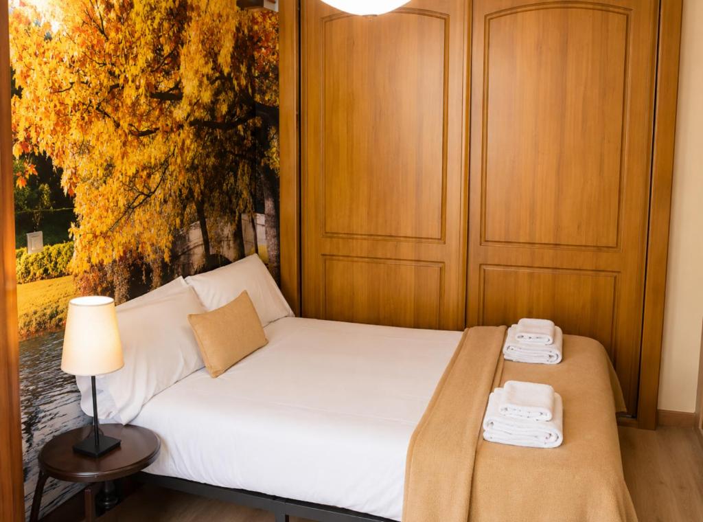 a bedroom with a bed with two phones on it at Casa Ilera II, en el corazon de Rioja Alta 8 PAX in Casalarreina