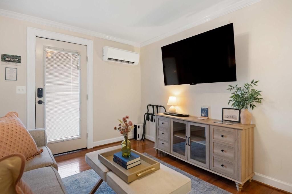 a living room with a flat screen tv on the wall at Historic Riverview Inn Suite Nine in Chattanooga