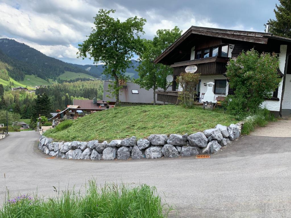 a house with a mound of grass in front of it at Landhaus Alpenstern in Riezlern