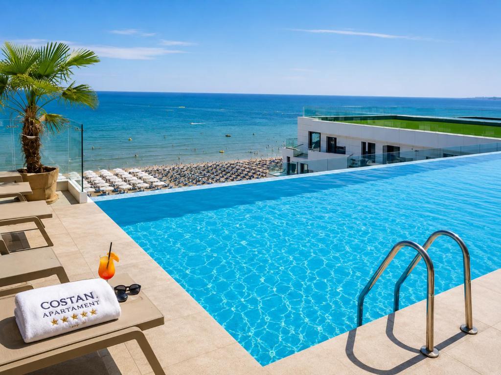 a swimming pool with a view of the ocean at CosTan Apartment Infinity Spa & Parking in Mamaia Sat/Năvodari