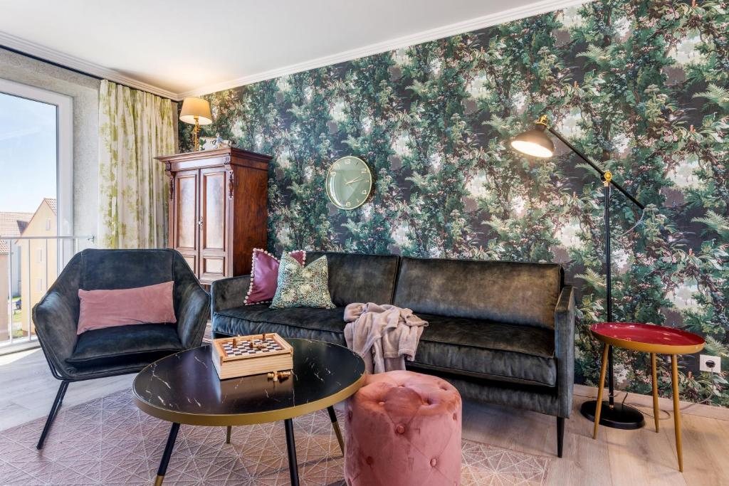 a living room with a couch and a table at Ferienwohnung Rosen am Meer in Sassnitz