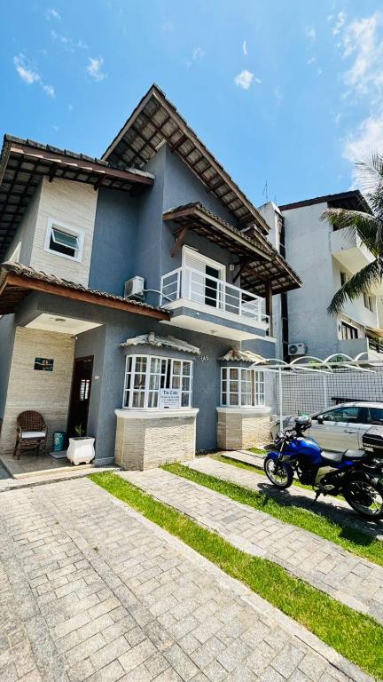 a motorcycle parked in front of a house at Pousada do Tio Cido in Guarujá