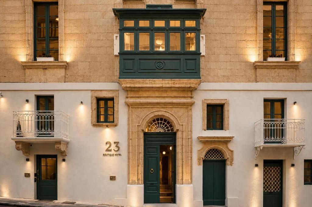 a building with a green door and a window at 23 Boutique Hotel in Il-Furjana