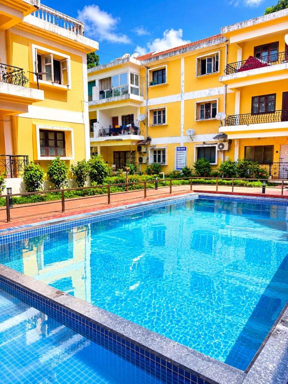 a large swimming pool in front of a building at Tony apartment baga in Baga