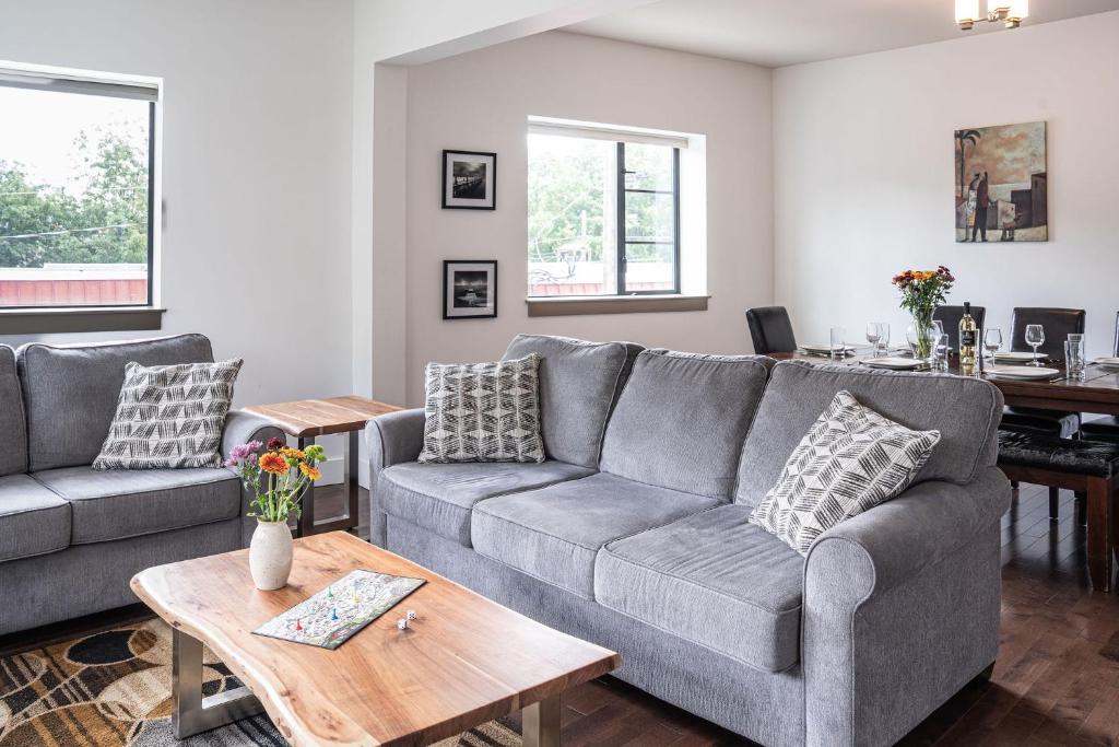 a living room with a couch and a table at Selkirk Snug by Revelstoke Vacations in Revelstoke