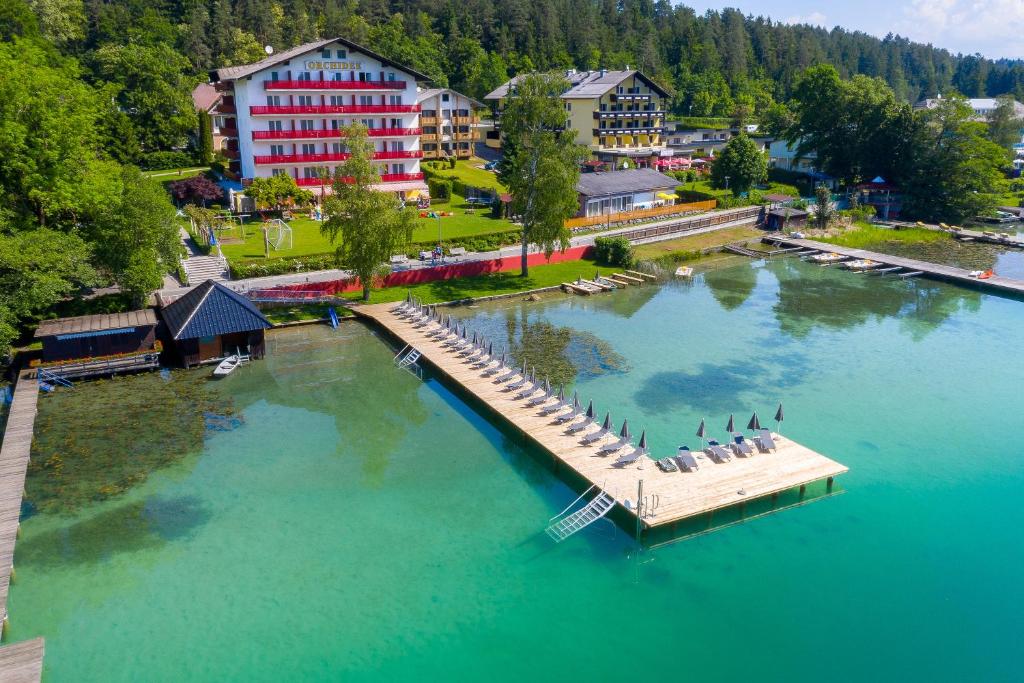 an aerial view of a resort with a dock in the water at Strandhotel Orchidee in Sankt Kanzian