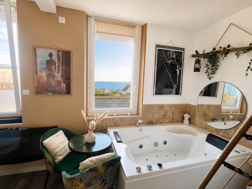a large bathroom with a large tub and a window at L'instant d'évasion Vue mer in Lampaul-Plouarzel