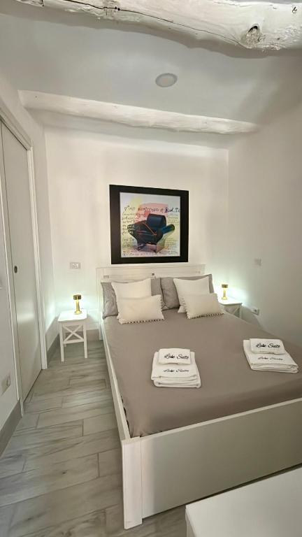 a white bedroom with a large bed in a room at Lake Suite in Trevignano Romano