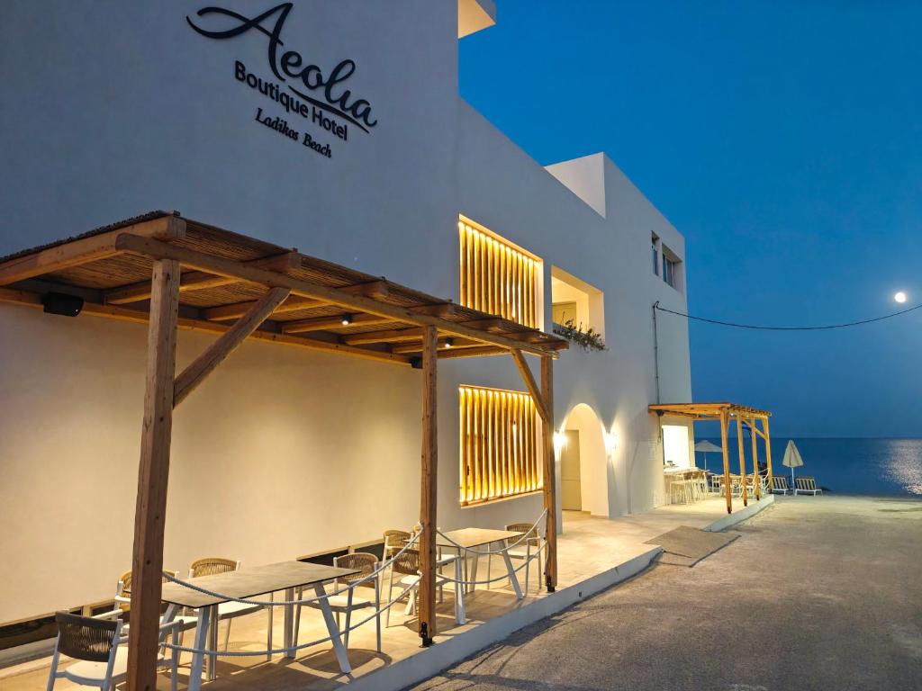 a restaurant with tables and chairs on the side of a building at Aeolia Seaside Hotel in Kardamaina