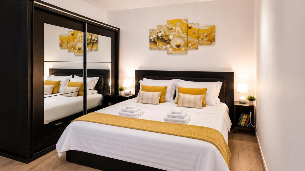 a bedroom with a large bed with yellow pillows at Studio Veronica - Ultracentral, langa Tomis Mall, Self Check-in, Free Parking, Fast WiFi, 10 min Plaja Modern in Constanţa